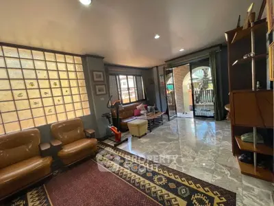 Spacious living room with elegant decor and large windows for natural light.
