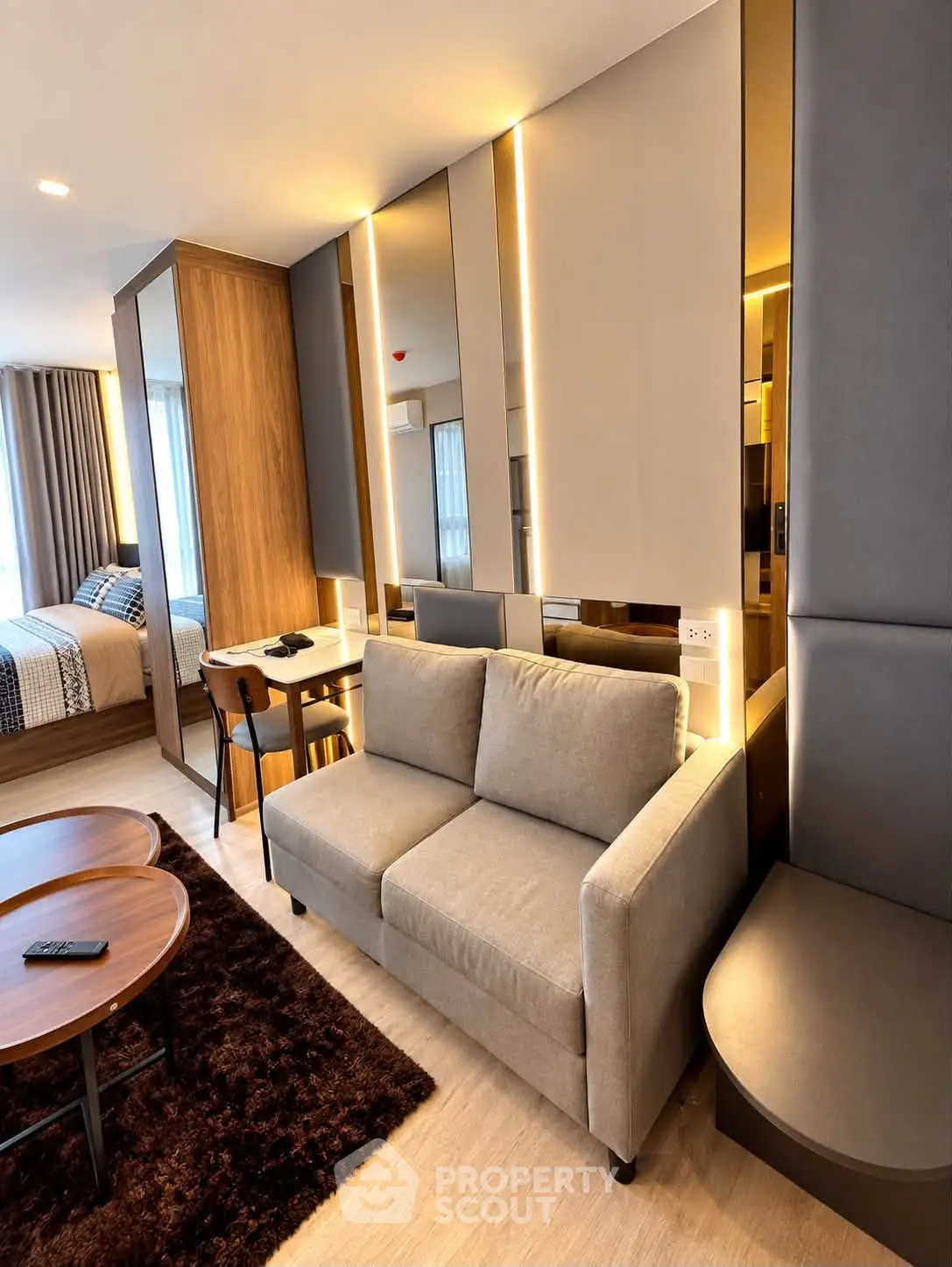 Modern studio apartment with cozy living area and stylish bedroom