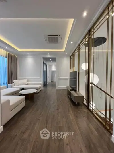 Luxurious modern living room with elegant decor and spacious layout, featuring stylish furniture and ambient lighting.