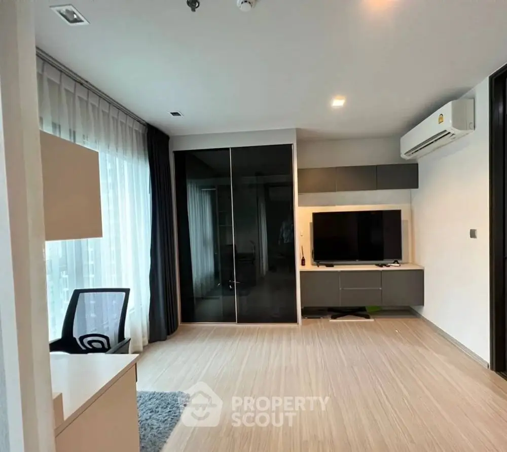 Modern living room with sleek furniture and large windows for natural light.