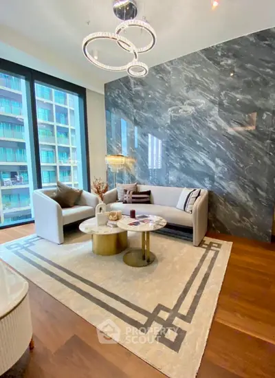 Luxurious modern living room with elegant marble accent wall and stylish furniture.