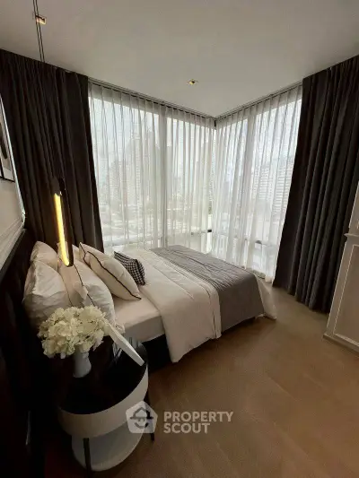 Luxurious corner bedroom with floor-to-ceiling windows and elegant decor in a modern apartment.