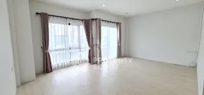 Spacious empty living room with large windows and natural light