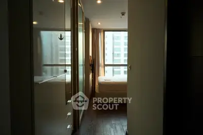 Cozy bedroom with large window and modern furnishings in urban apartment