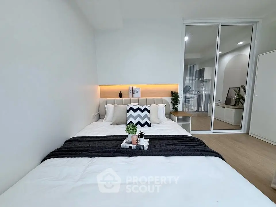 Modern bedroom with stylish decor and cozy ambiance in a contemporary apartment.