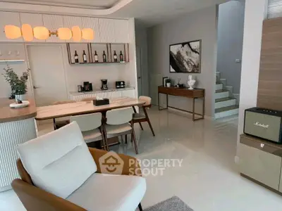 Modern open-plan living and dining area with stylish furniture and elegant decor.