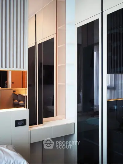 Modern bedroom with sleek built-in storage and stylish design elements.
