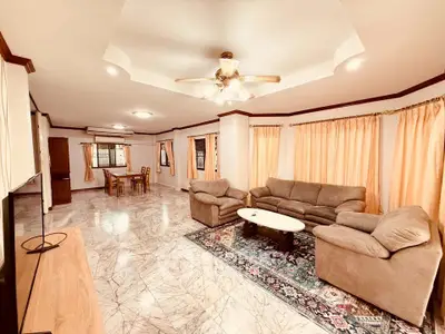 Spacious living room with elegant marble flooring and cozy seating area