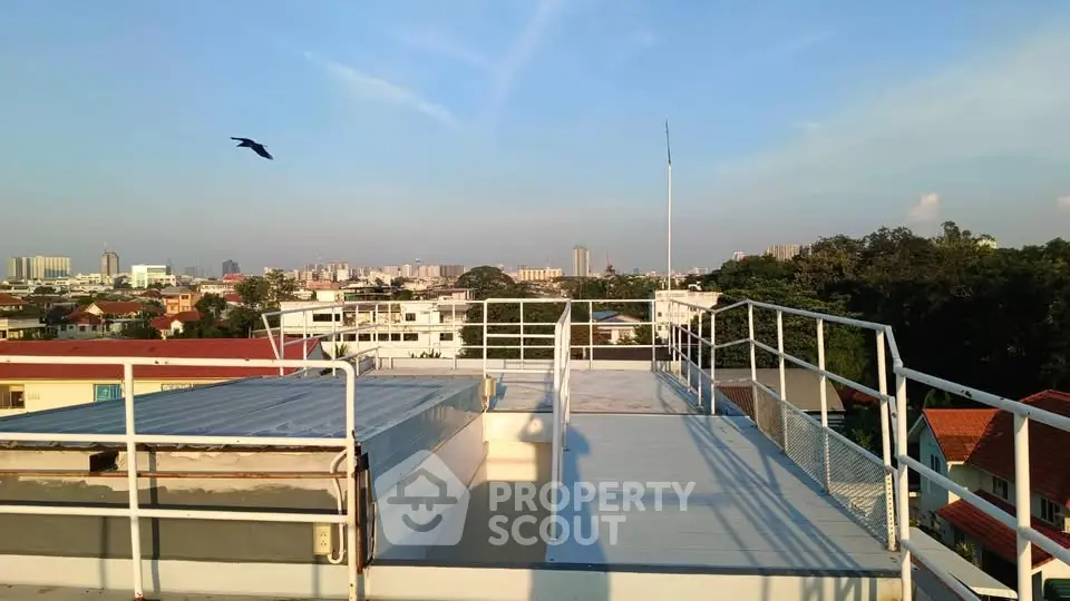 Stunning rooftop view with city skyline and clear blue sky, perfect for urban living enthusiasts.