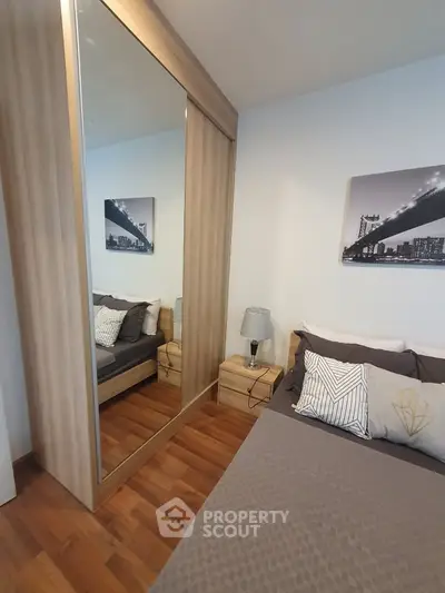 Cozy bedroom with mirrored wardrobe and stylish decor