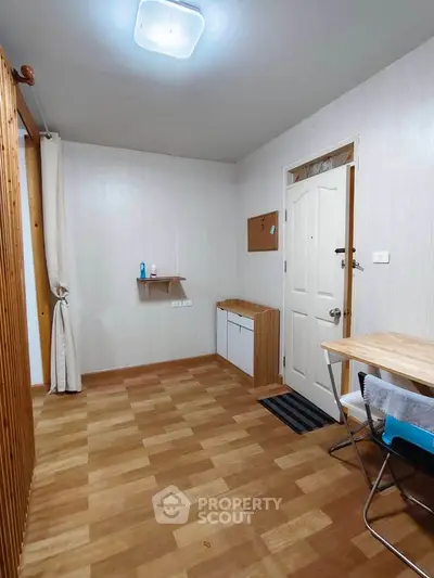 Cozy entryway with wooden flooring and minimalist decor