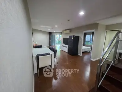 Spacious open-plan living area with dining table and modern appliances