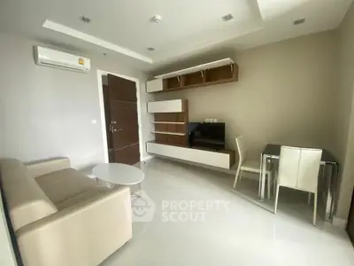 Modern living room with sleek furniture and wall-mounted storage in a stylish apartment.