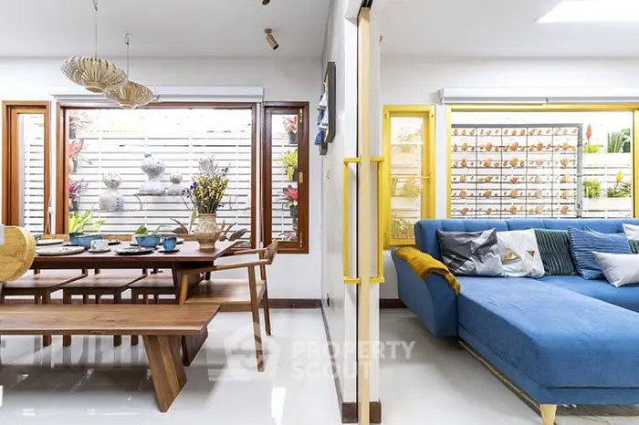 Spacious living room with modern decor and large windows for natural light.