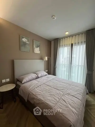 Modern bedroom with cozy bed and large window in stylish apartment