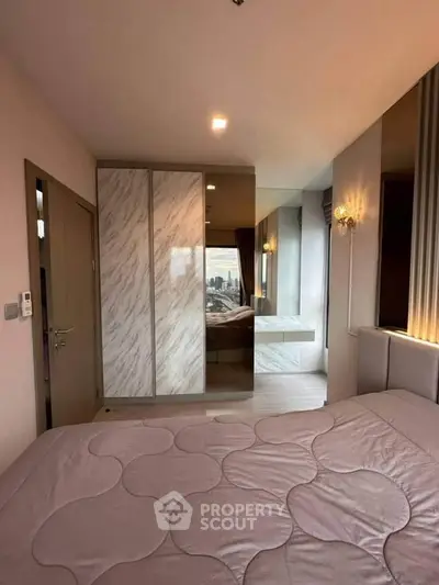 Modern bedroom with city view, featuring stylish decor and ample natural light.