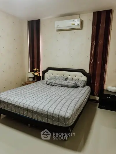 Cozy bedroom with modern decor and air conditioning, perfect for restful nights.