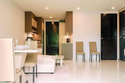 Modern open-plan living room with elegant dining area and stylish kitchen in a contemporary apartment.
