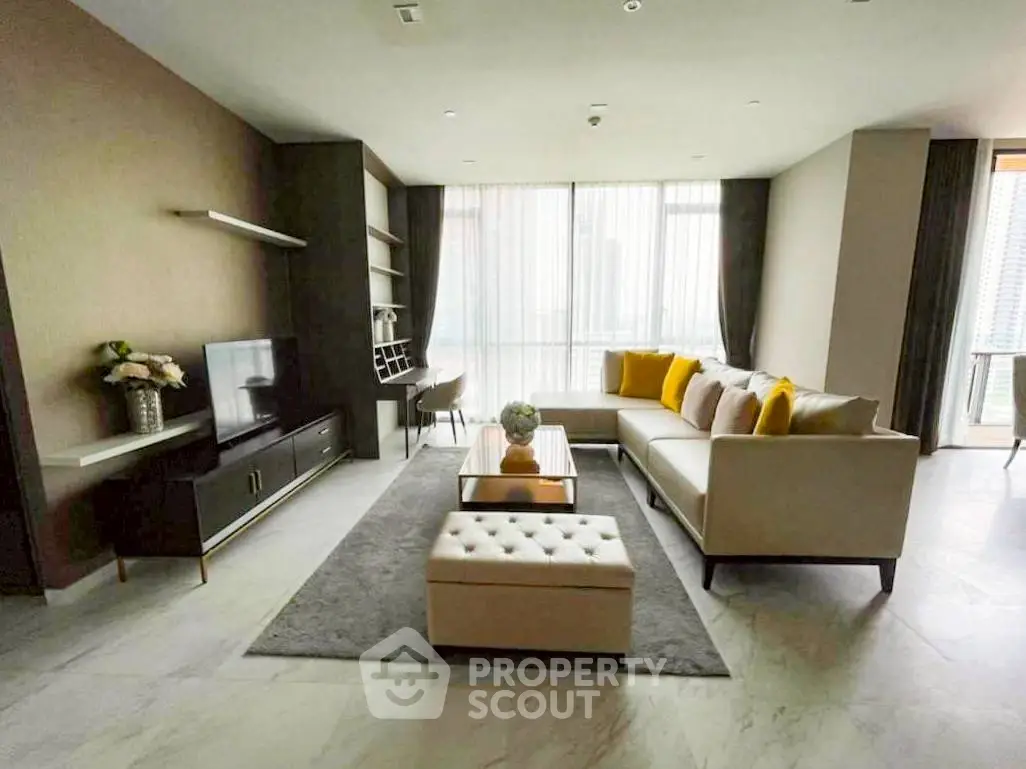 Spacious modern living room with elegant decor and large windows.