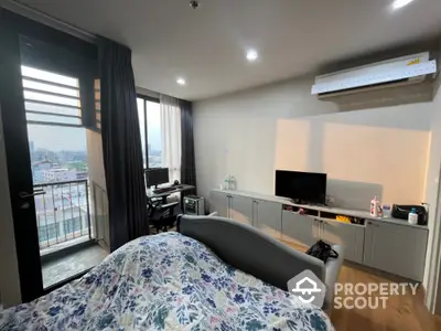 Modern bedroom with balcony and city view, featuring air conditioning and stylish decor.