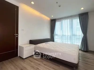 Modern bedroom with large window and minimalist design