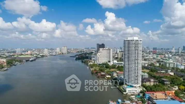 Stunning riverfront cityscape with high-rise buildings and expansive water views.
