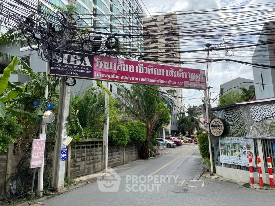 Urban street view with residential buildings and lush greenery