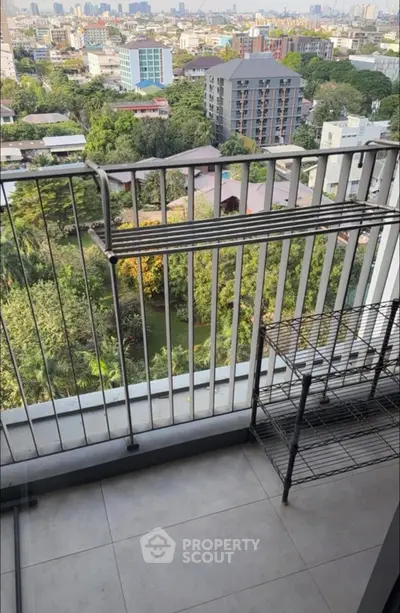 Charming balcony with city view and greenery, perfect for relaxation and enjoying the outdoors.