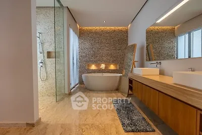 Luxurious modern bathroom with freestanding tub and elegant stone wall accents.