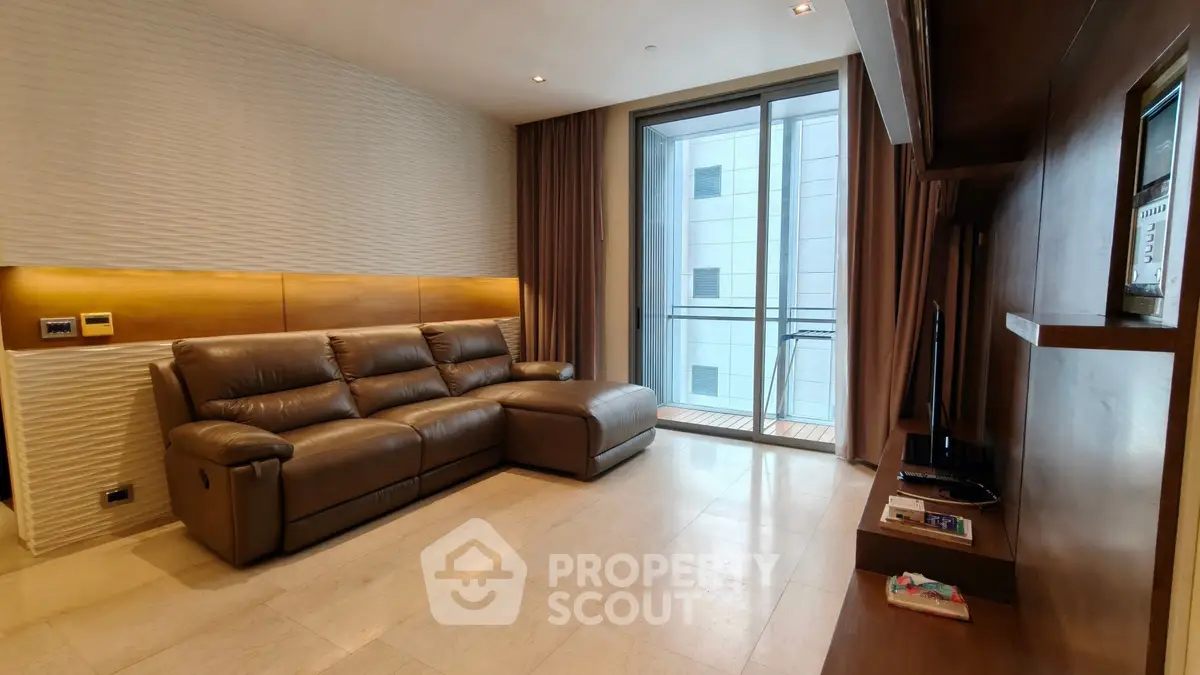 Modern living room with leather sofa and balcony view in luxury apartment