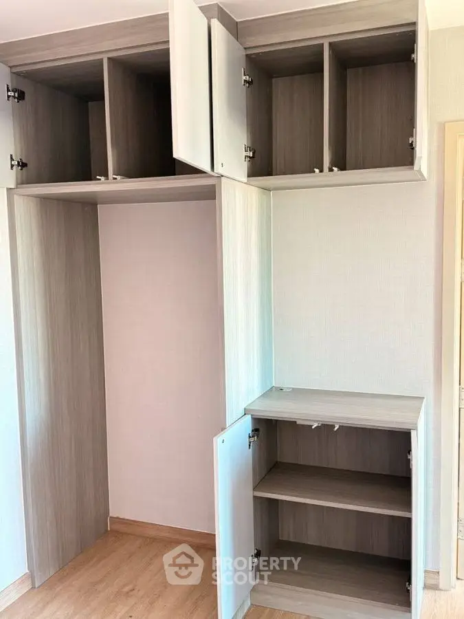 Spacious built-in storage cabinets in modern apartment interior.