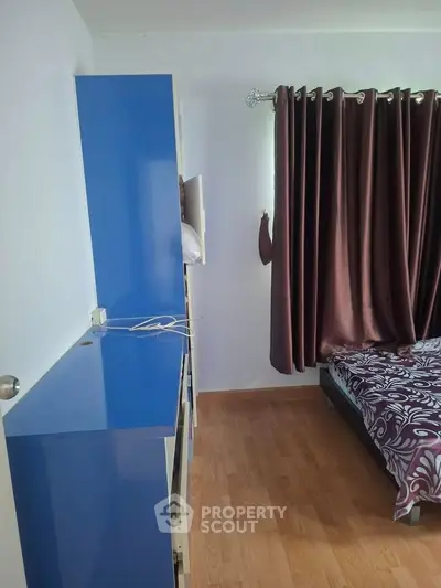 Cozy bedroom with blue wardrobe and elegant curtains
