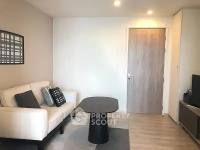 Modern living room with stylish furniture and wooden flooring in a cozy apartment.