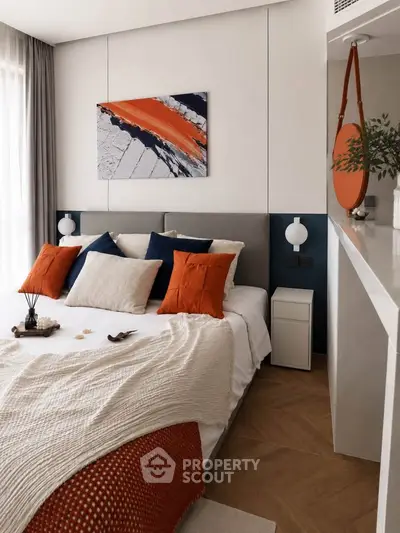 Modern bedroom with stylish decor and vibrant orange accents