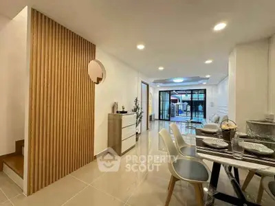 Modern open-plan living and dining area with stylish decor and ample natural light.