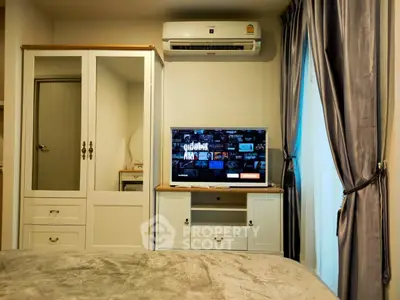 Cozy bedroom with modern air conditioning and stylish TV setup