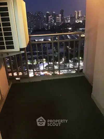 City view from a high-rise balcony at night with urban skyline
