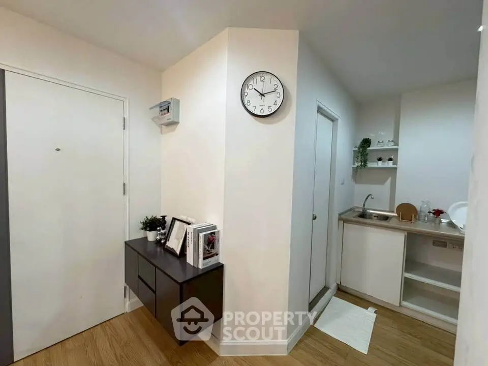 Modern apartment entrance with compact kitchen and stylish decor