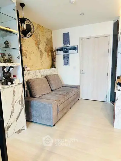 Stylish living room with modern decor and cozy sofa in a compact apartment.