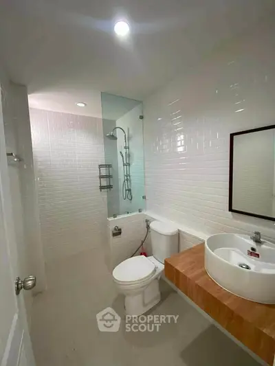 Modern bathroom with sleek design, featuring a bathtub and contemporary fixtures.