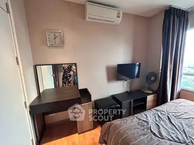 Cozy bedroom with modern furniture and city view, featuring air conditioning and stylish decor.