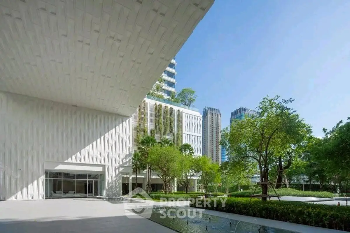 Modern architectural building with lush garden and city skyline view