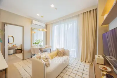 Modern living room with elegant decor and natural light in a stylish apartment.