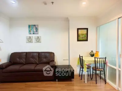 Cozy living room with brown leather sofa and small dining area, perfect for urban living.