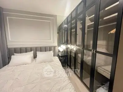 Elegant bedroom with mirrored wardrobe and plush bedding