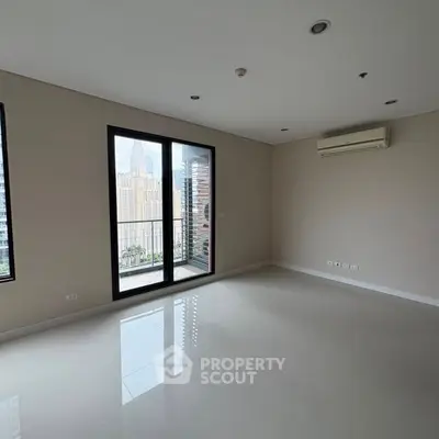 Spacious empty living room with large windows and city view