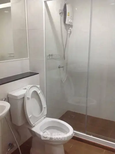 Modern bathroom with glass shower and sleek fixtures in a contemporary apartment.