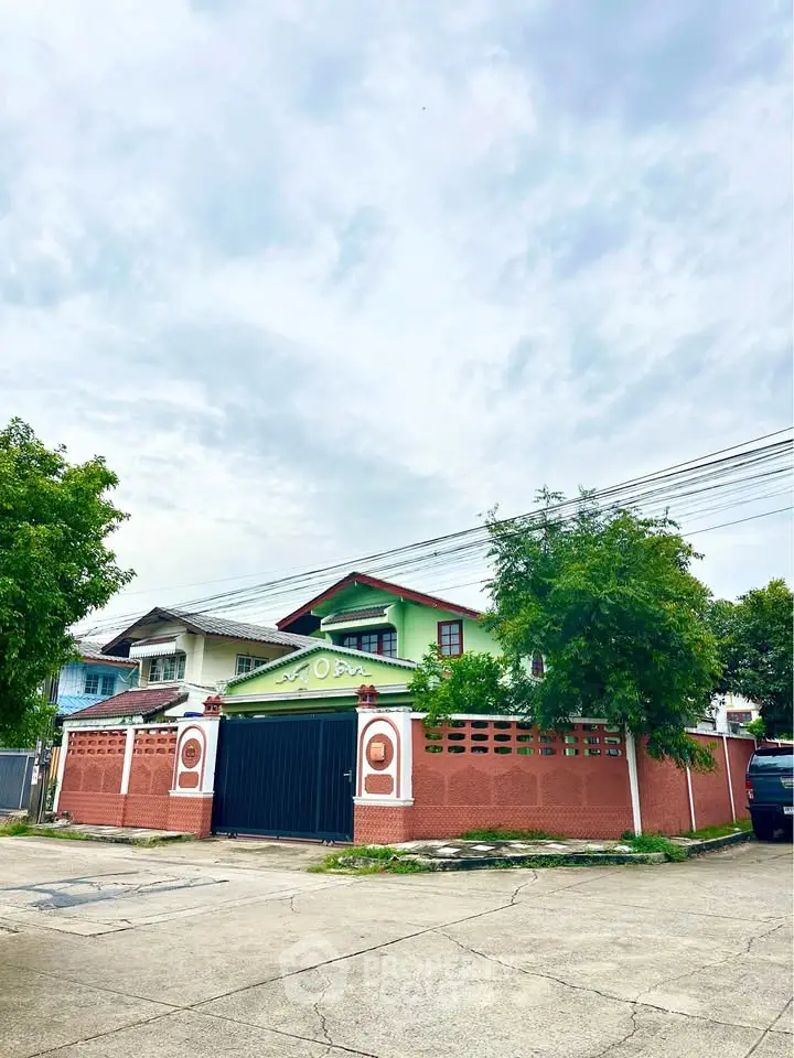 Charming suburban home with vibrant exterior and lush greenery, perfect for family living.