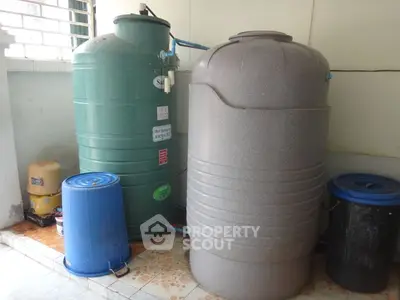 Utility room with large water storage tanks and containers