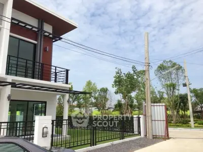 Modern two-story house with spacious garden and sleek balcony design